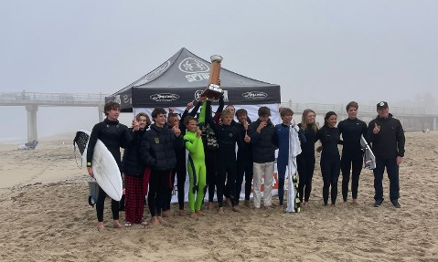 Mira Costa Surf Team holding the league cup trophy in front of the judges tent on the beach with Hermosa Beach Pier in the background. Mira Costa Surf Team holding the league cup trophy in front of the judges tent on the beach with Hermosa Beach Pier in the background.