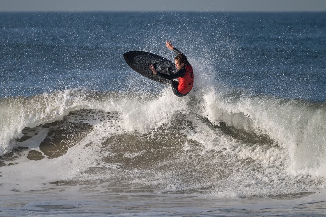 Cole Saffell front side air on all carbon black surfboard Cole Saffell front side air on all carbon black surfboard